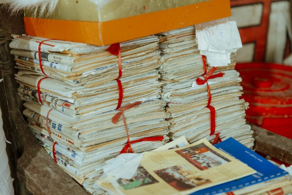 Bundles of newspapers bound together, showcasing vintage reading material.